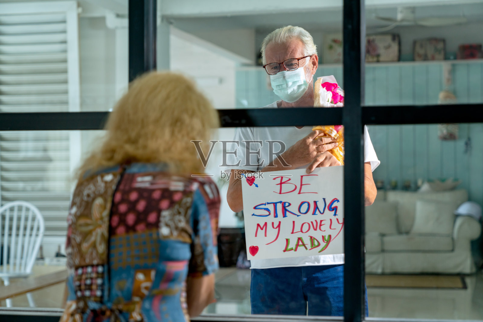 有选择地集中于老年男性通过窗口探望隔离中的妻子照片摄影图片
