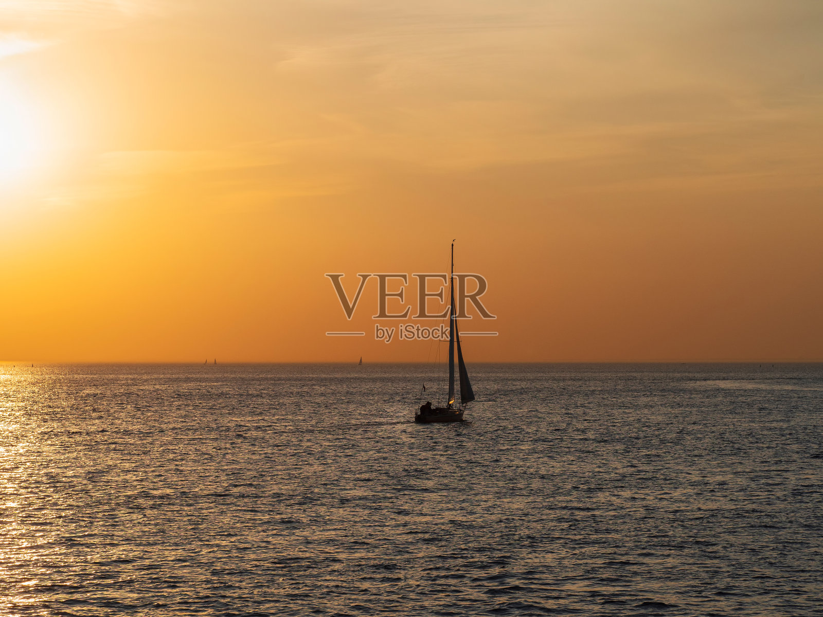 游艇在日落平静。简约的海景。照片摄影图片