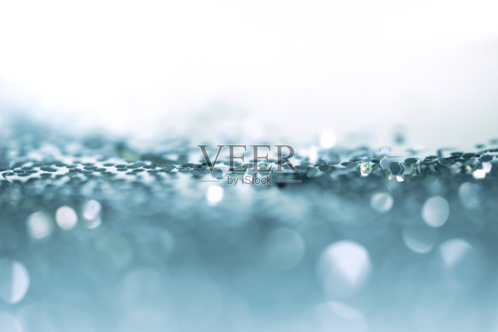 蓝色闪光点纸屑。抽象的光闪烁闪烁散焦背景。照片摄影图片