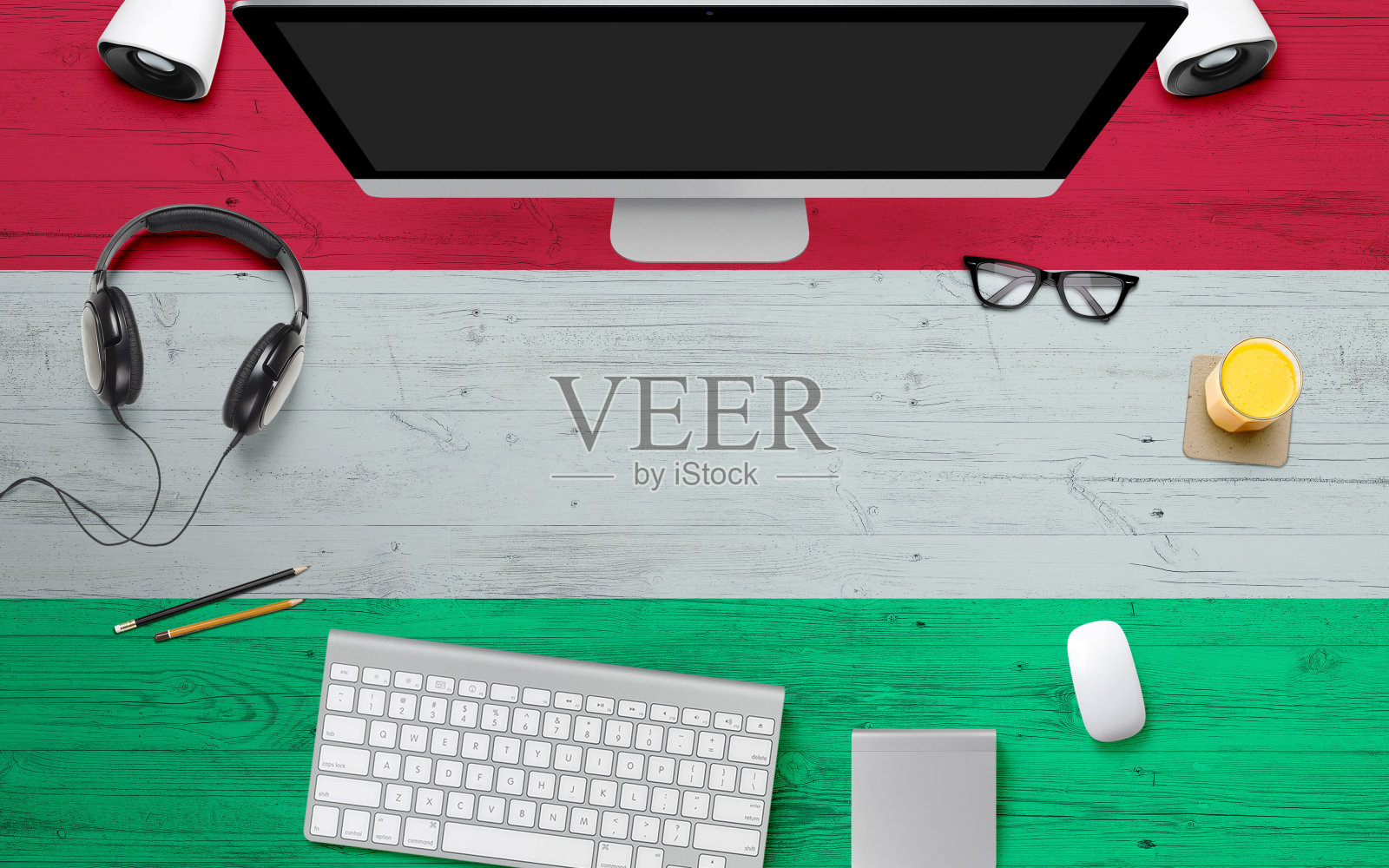 匈牙利国旗背景配有耳机,电脑键盘和鼠标放在国家办公桌上。顶部视图与复制空间。平的。照片摄影图片