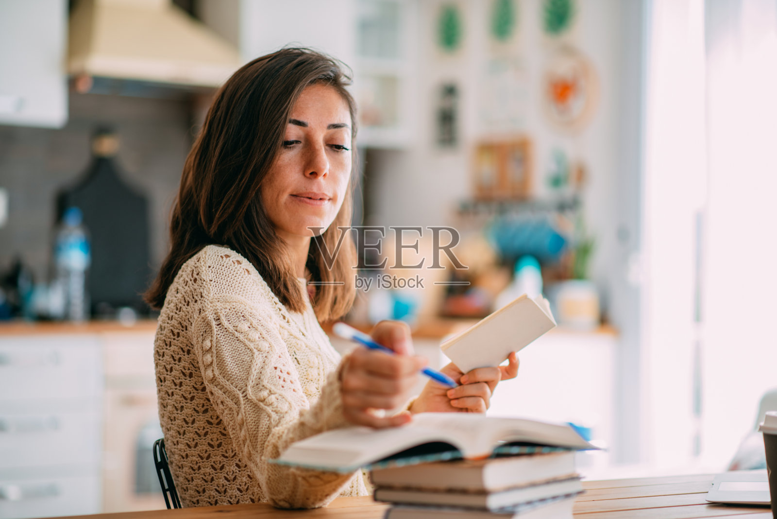 学生用铅笔在打开的笔记本上写字照片摄影图片