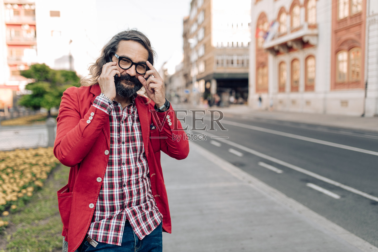 一个成熟男人的肖像走在大街上,讲着电话照片摄影图片