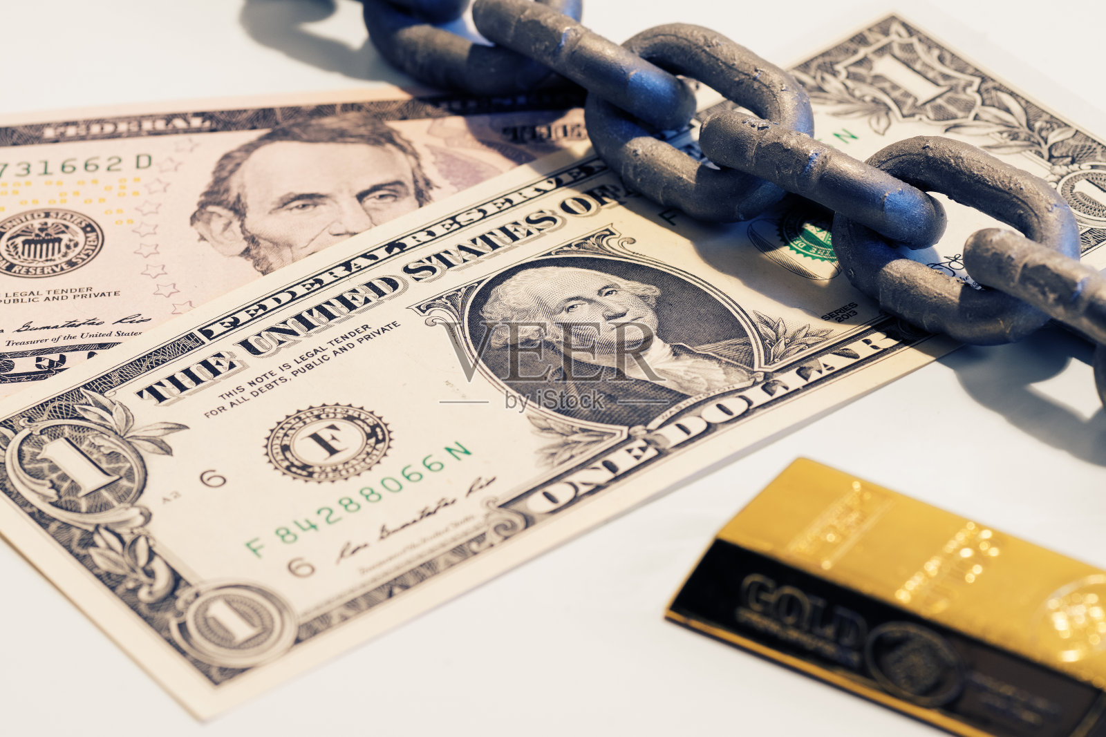 一美元和五美元的钞票,金条和钢链照片摄影图片