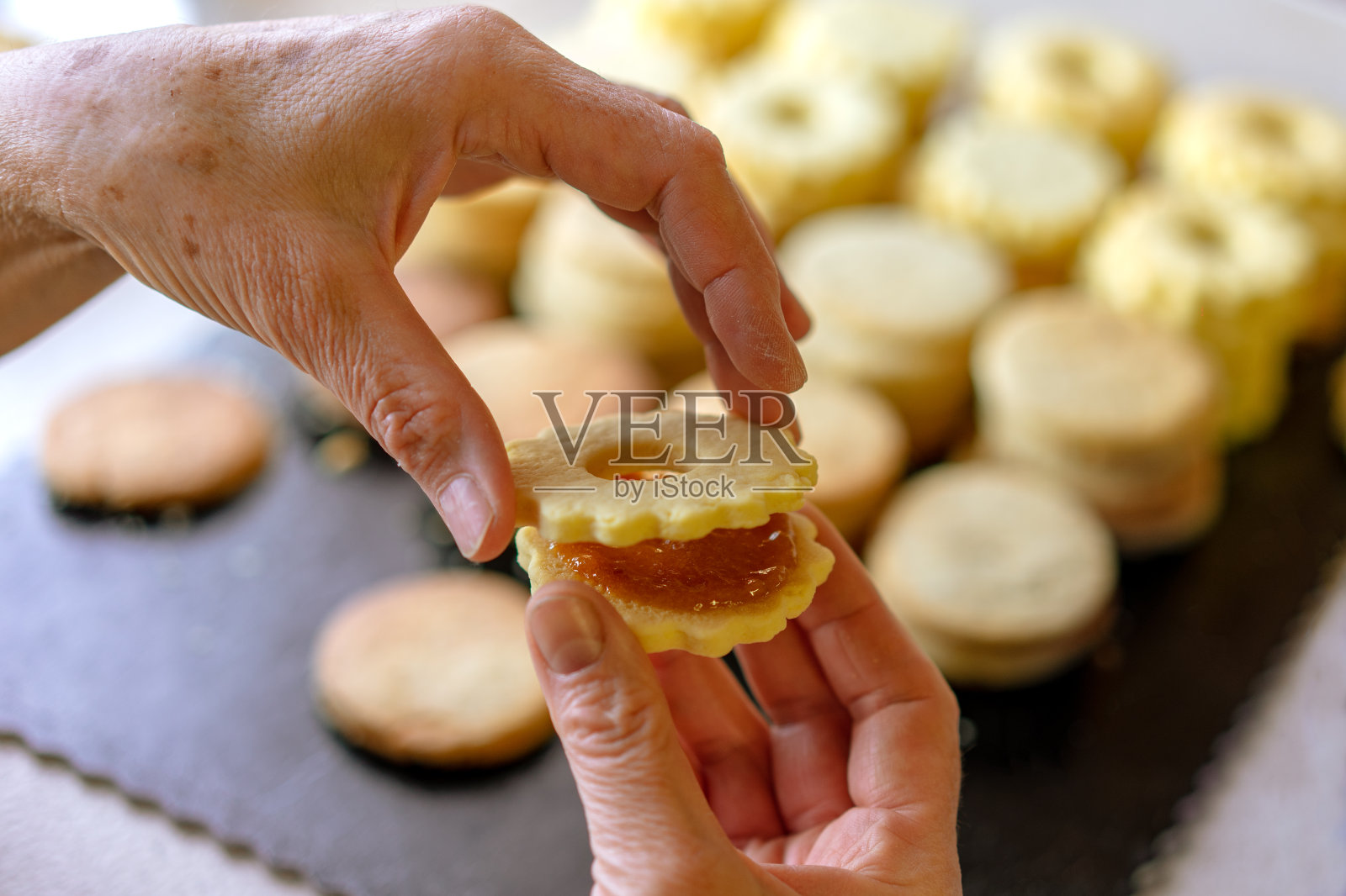 奶奶在做传统的德国圣诞饼干林泽饼干里面有橘子酱照片摄影图片