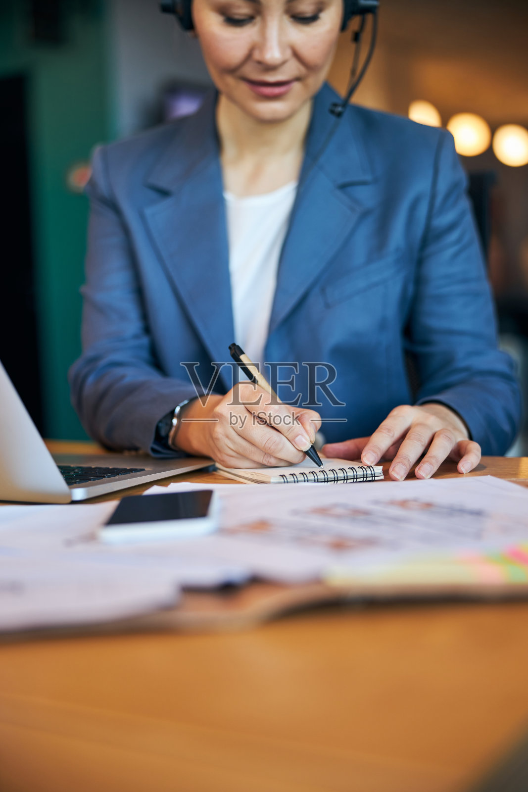 迷人的女商人在办公室笔记本上写字照片摄影图片
