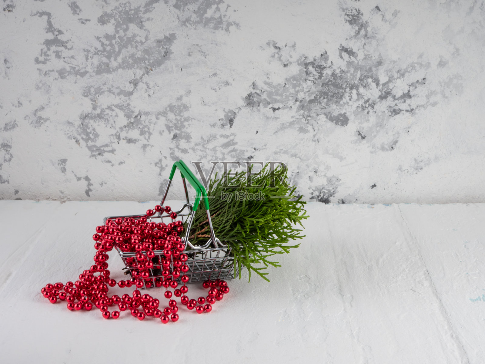 圣诞装饰品杂货店篮子里的红珠和云杉。照片摄影图片