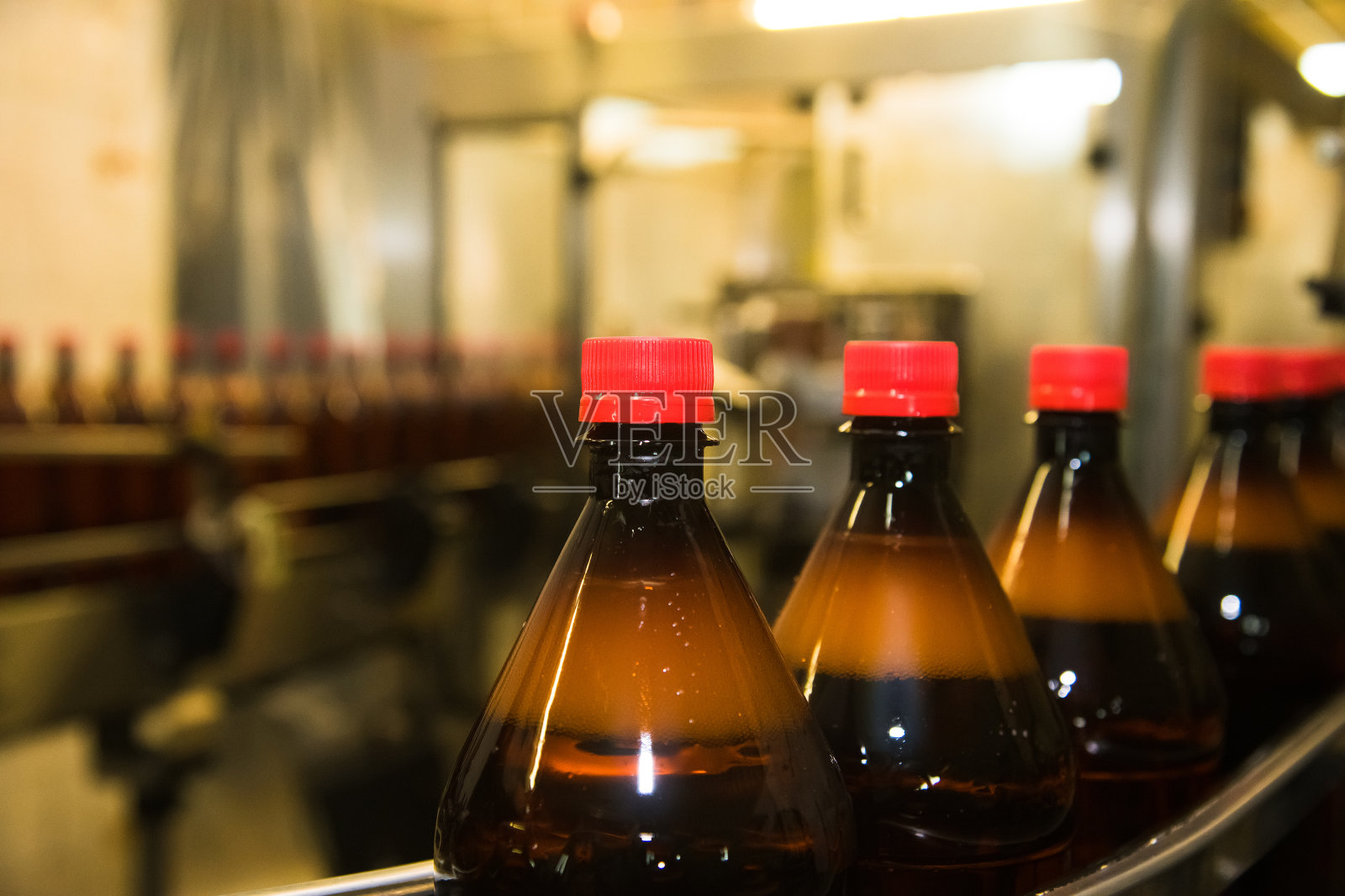 传送带上装着碳酸饮料的塑料瓶照片摄影图片