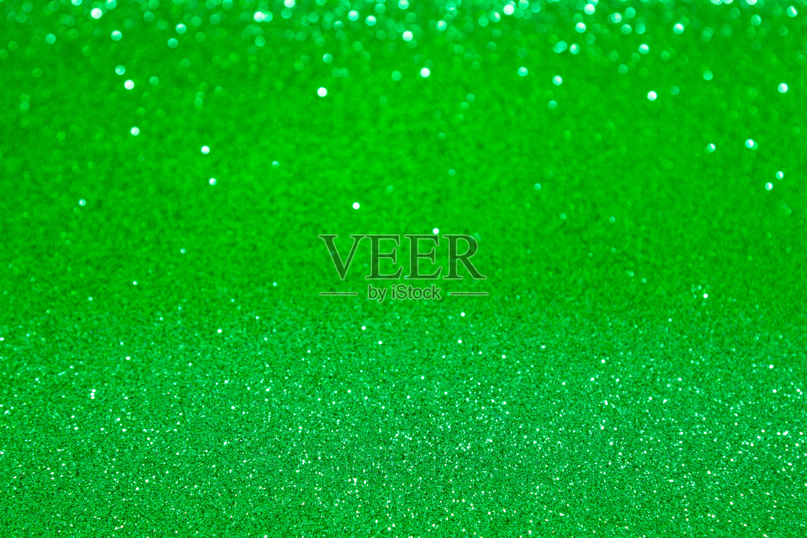 绿色亮片和散景背景。照片摄影图片