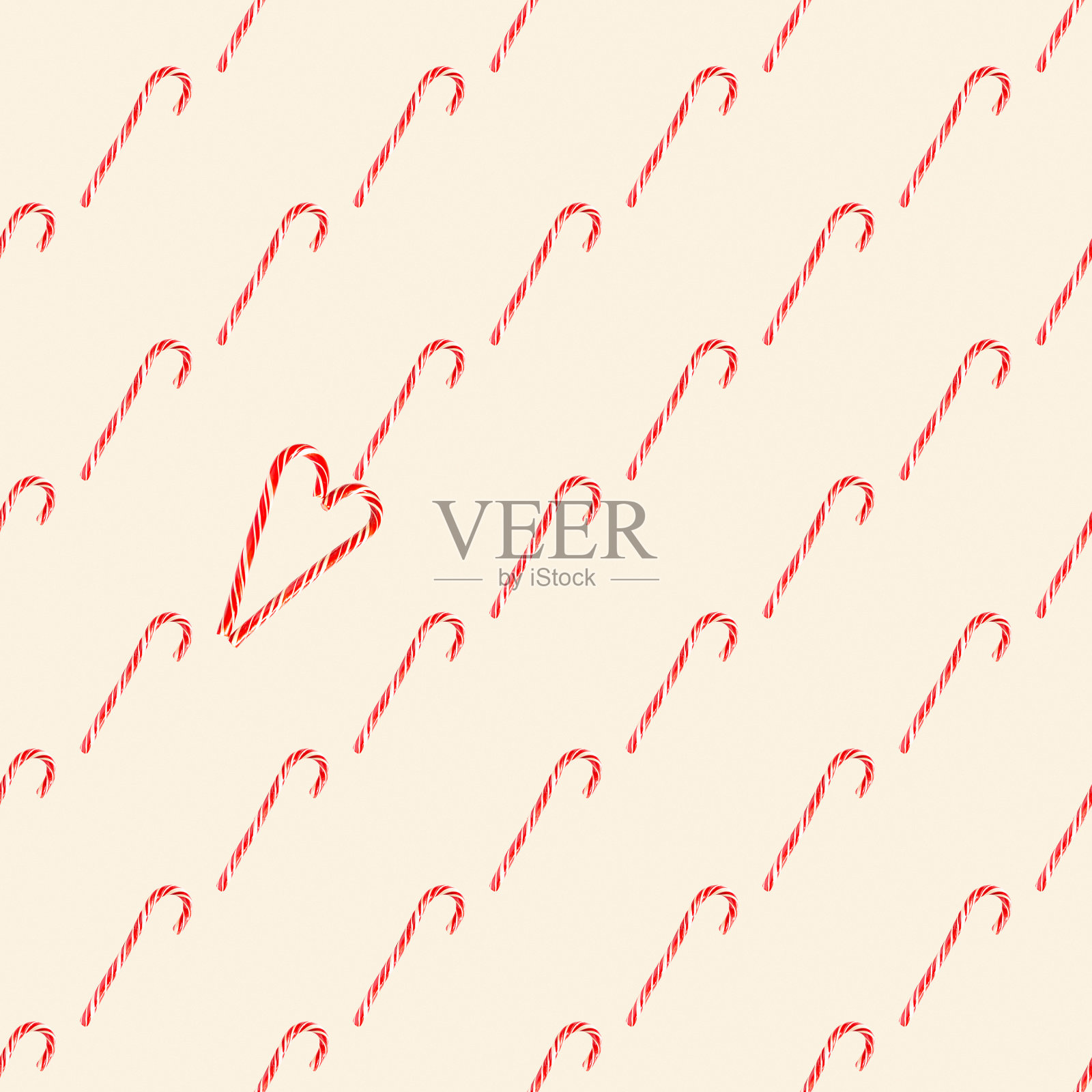 圣诞老人的红色条纹糖果手杖都堆成一颗心的形状无缝图案,点缀。圣诞节,新年,情人节,冬季的节日气氛为爱人和所爱的人照片摄影图片