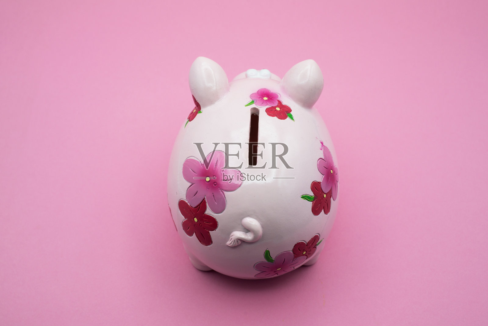 粉红色的花储蓄罐上顶视图粉红色的背景照片摄影图片