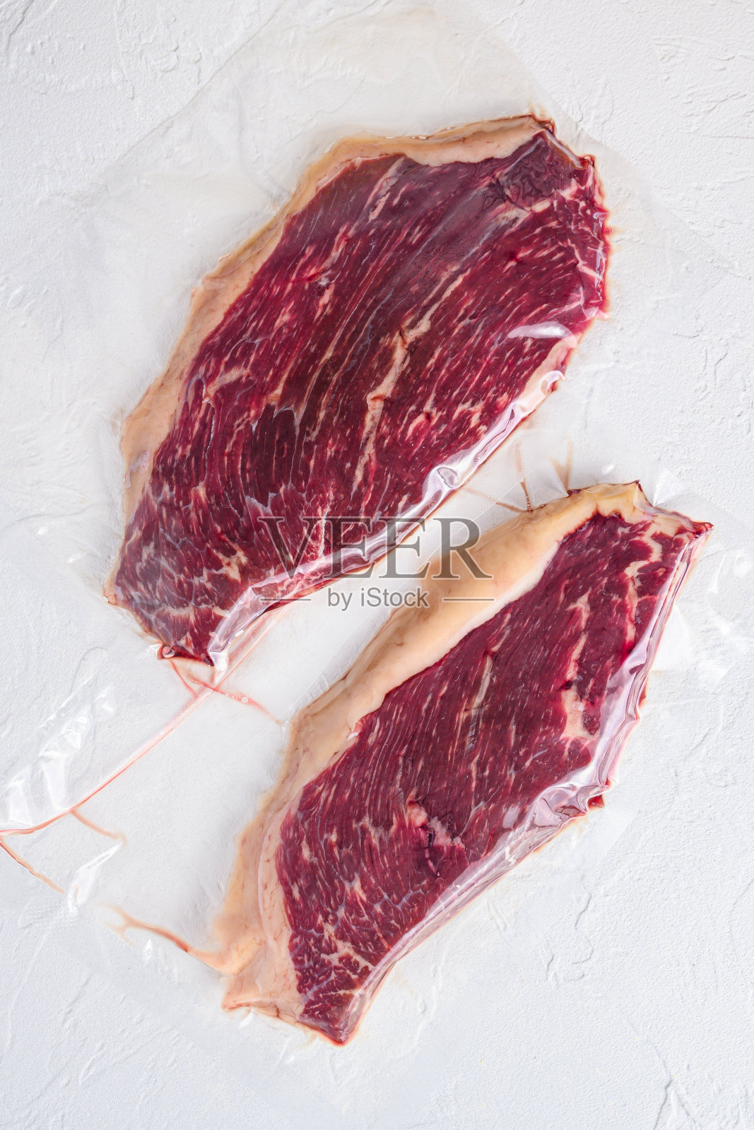 生picanha牛排真空包装有机牛肉在白色混凝土纹理背景,俯视图。照片摄影图片