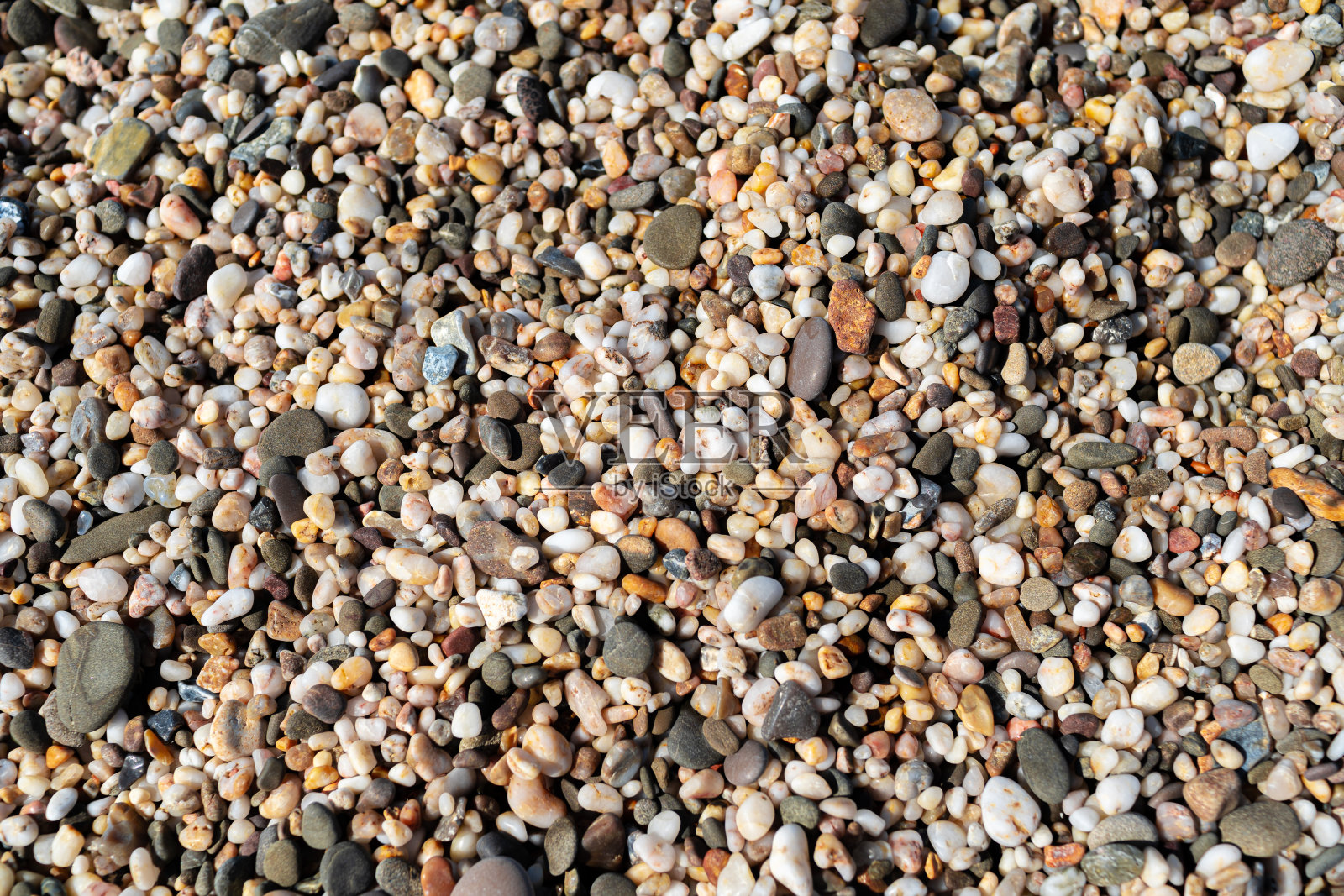 沙滩上的小卵石。海石头背景照片摄影图片