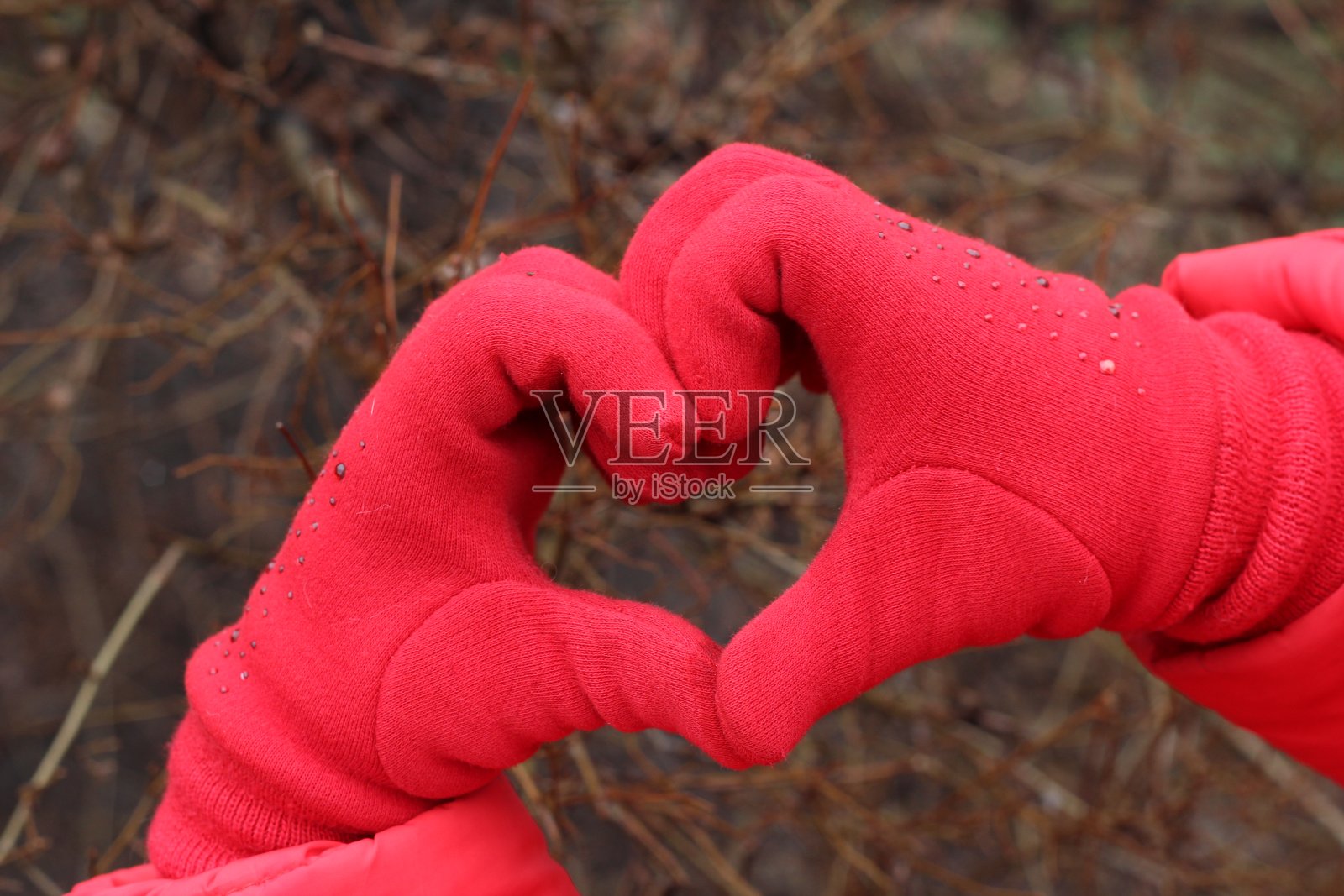 戴着红色手套的手的心照片摄影图片