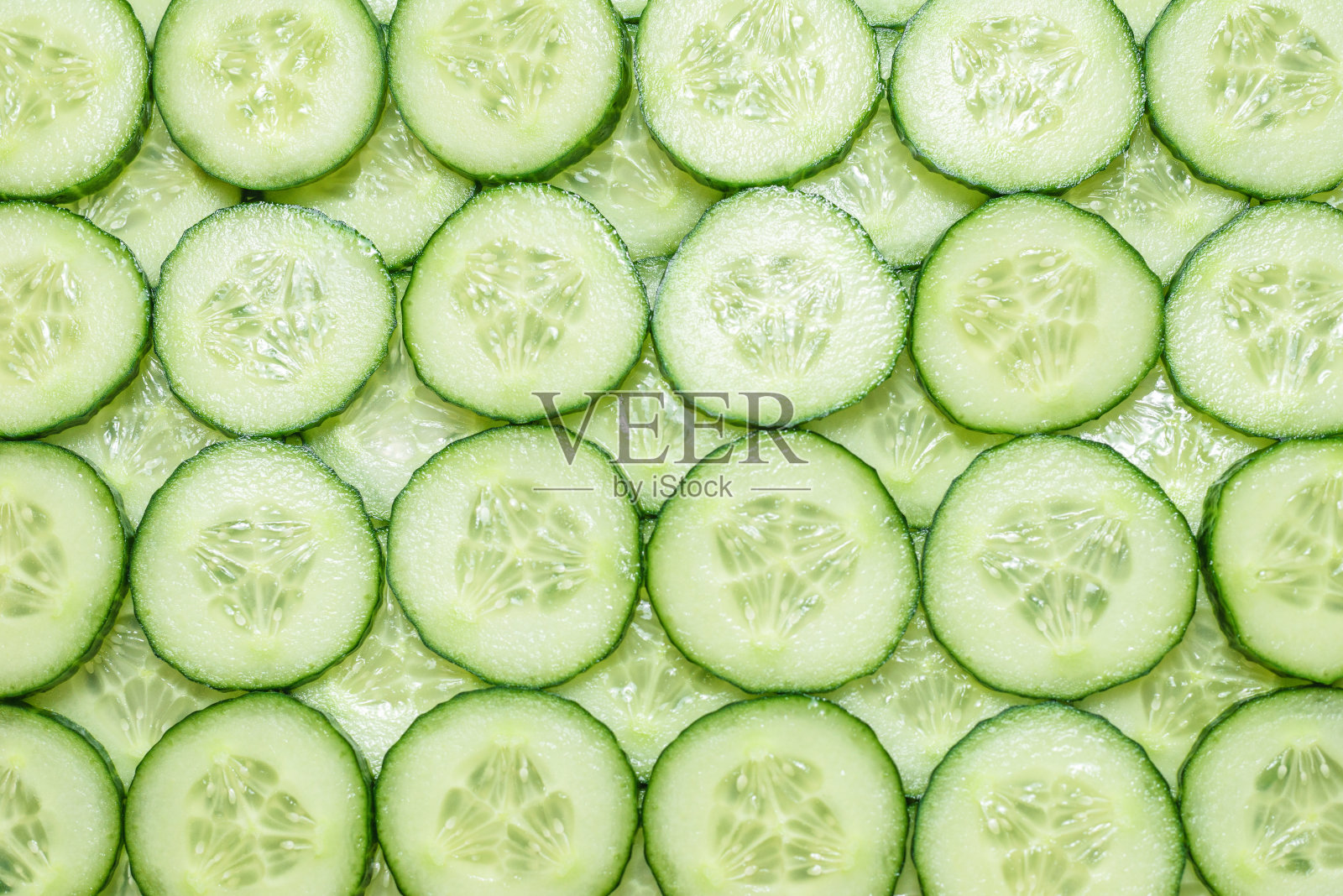 新鲜的绿色黄瓜片作为背景。照片摄影图片