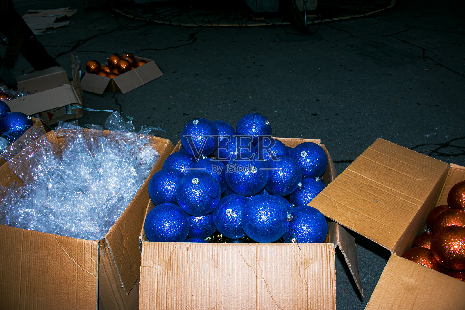 市政部门正在准备装饰城市的圣诞树。圣诞球在圣诞树附近的盒子里。装饰市政圣诞树的大型圣诞球。照片摄影图片