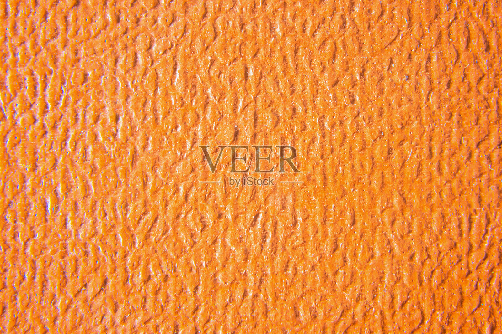 近距离的橙色皮革纹理。垃圾皮肤织物背景。照片摄影图片