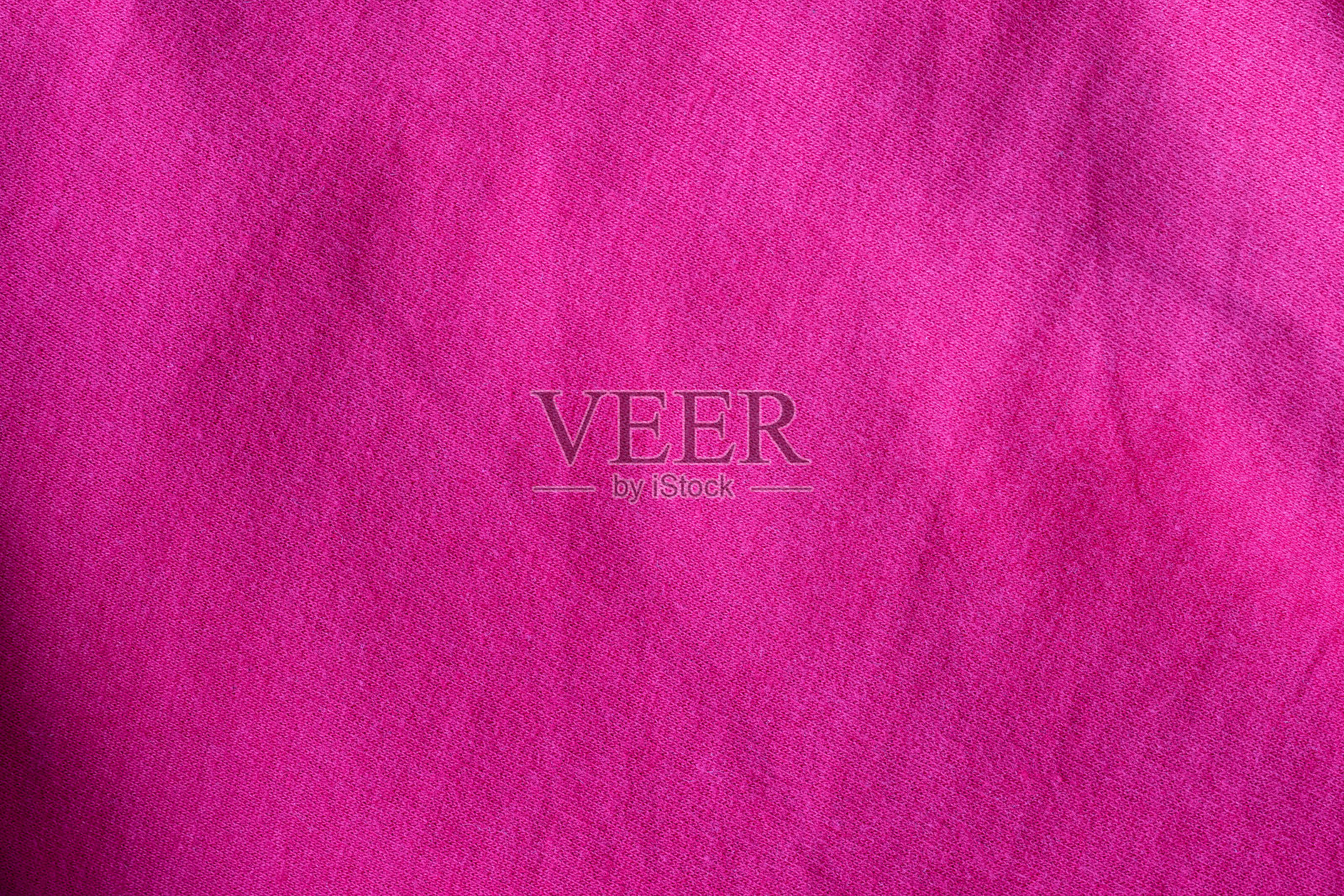 棉质针织物质地。皱巴巴的亮粉色纺织品背景照片摄影图片