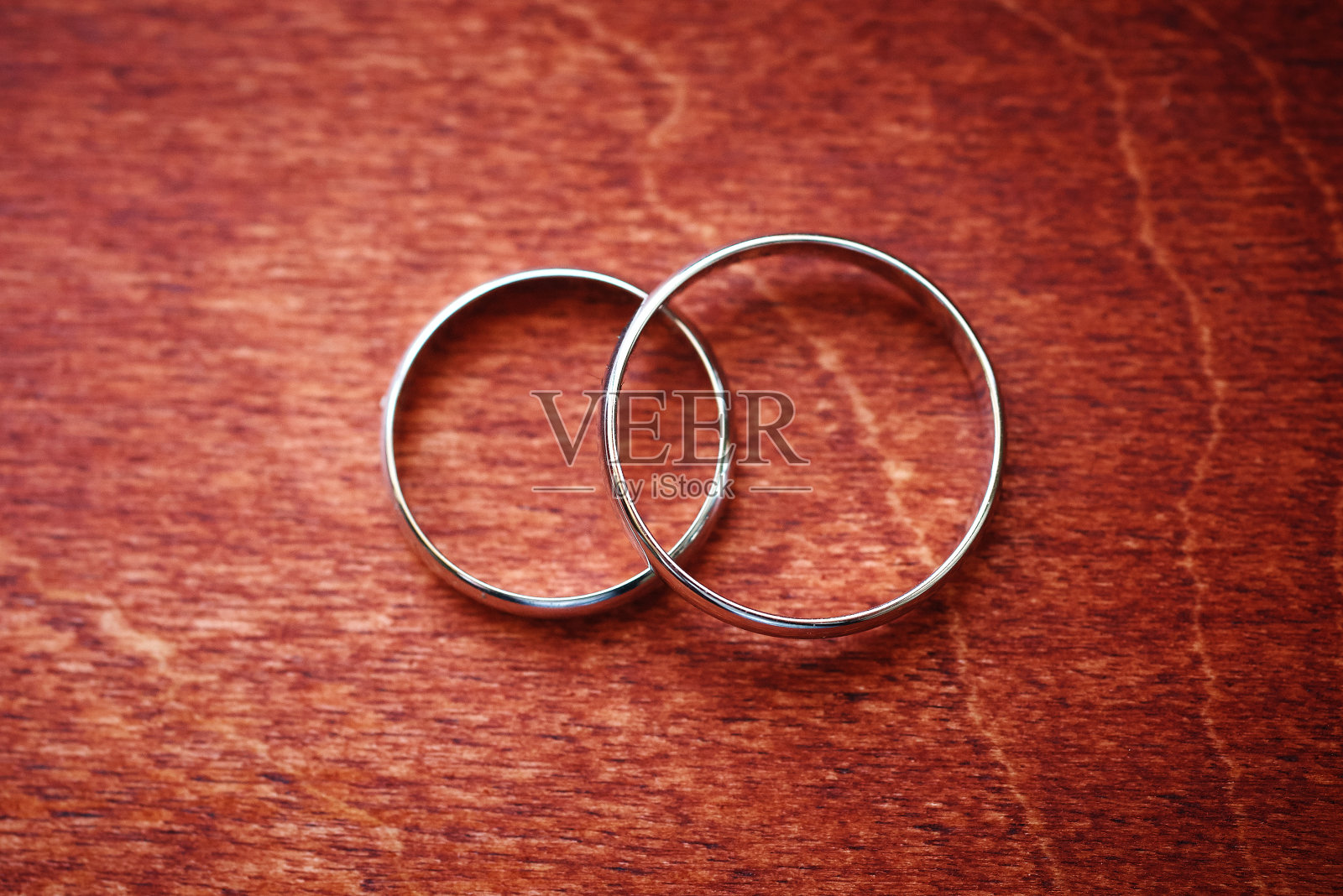 木制表面上的两个结婚戒指。为婚礼做准备。特写、宏照片摄影图片