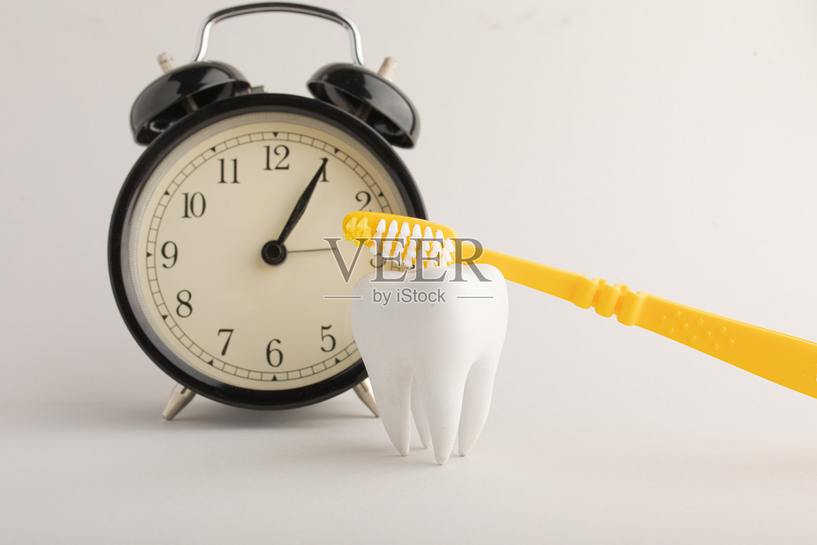 一套不同的牙科护理工具,背景有一个时钟,时间去看牙医照片摄影图片