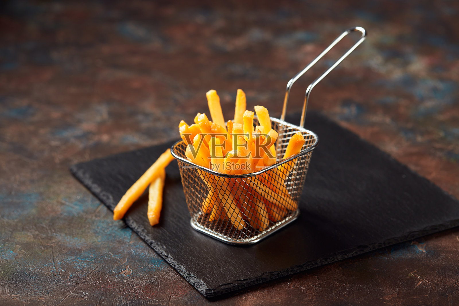 美味的薯条放在砧板上,放在木桌的背景上照片摄影图片