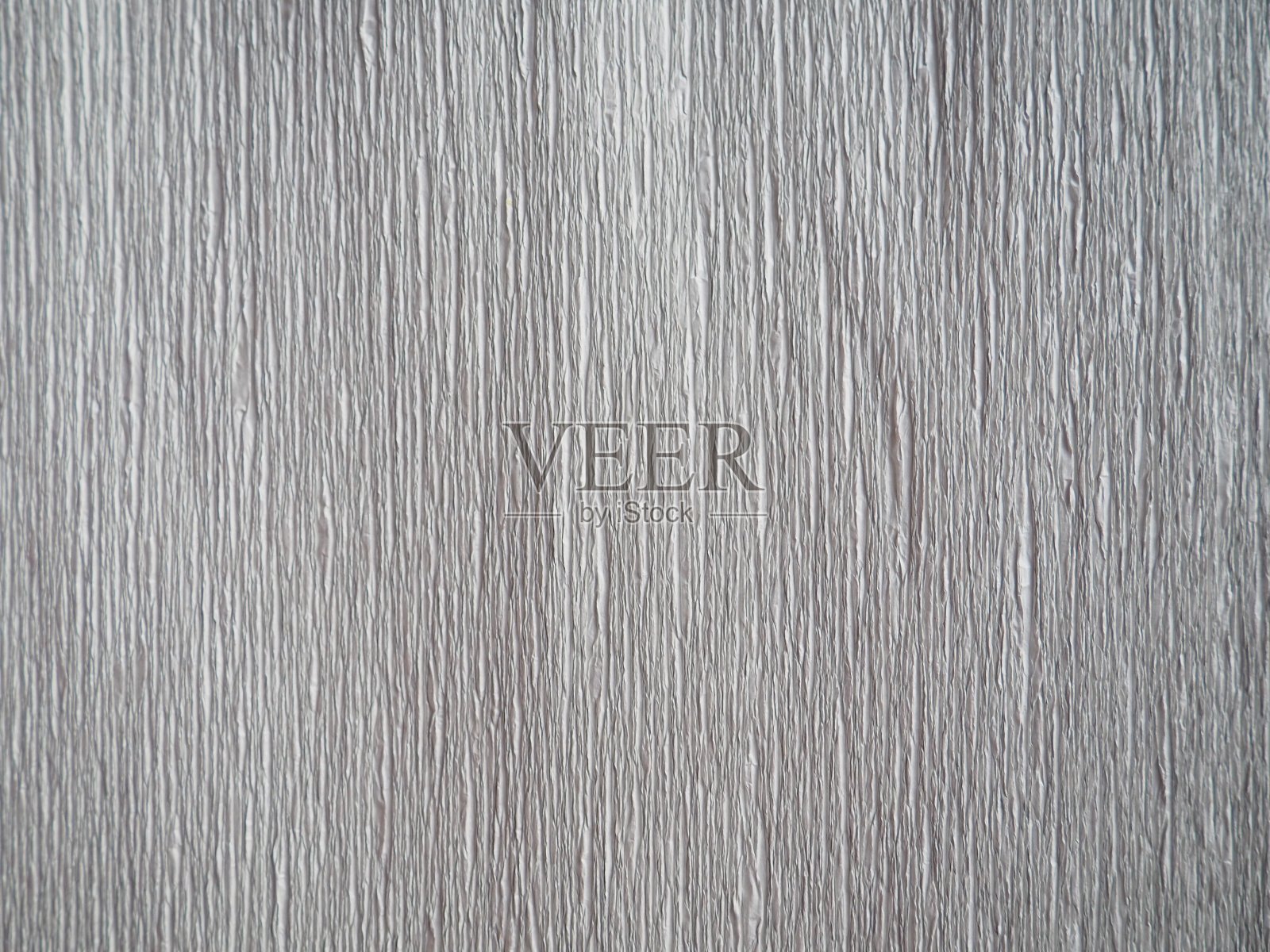 灰色的瓦楞纸。不均匀的表面。抽象的背景。纸的波纹边缘。照明梯度。瓦楞结构。照片摄影图片