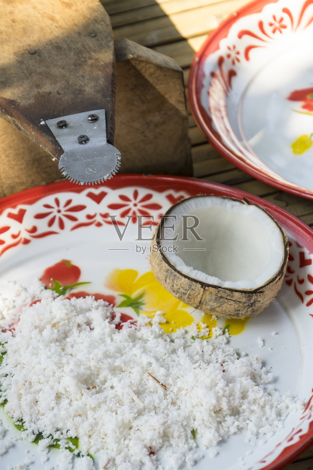 椰子切成两半,椰片环绕照片摄影图片