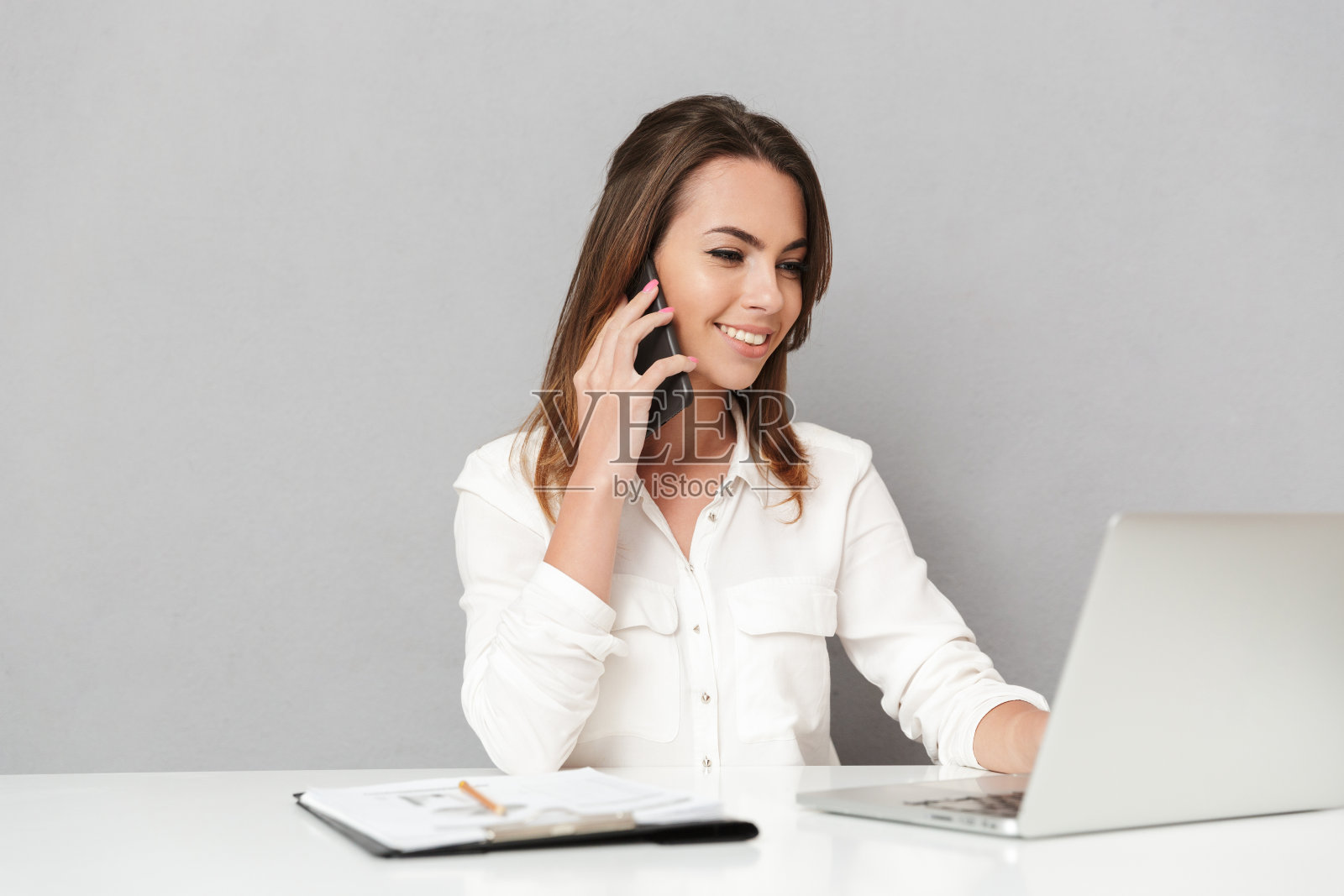 一个快乐的年轻商业妇女使用手机孤立的白色背景肖像照片摄影图片