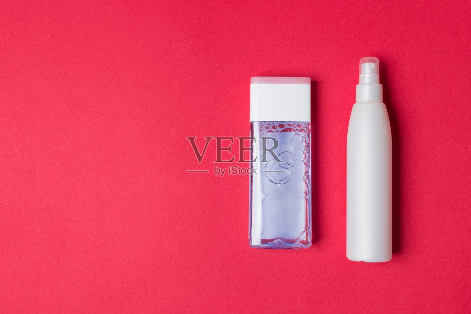 两个化妆瓶在红色背景与复制空间照片摄影图片