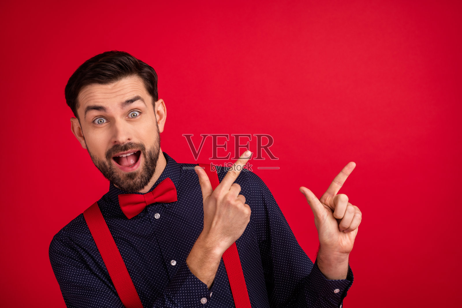 照片的年轻快乐兴奋疯狂微笑先生指指点点copyspace推荐孤立在红色背景照片摄影图片