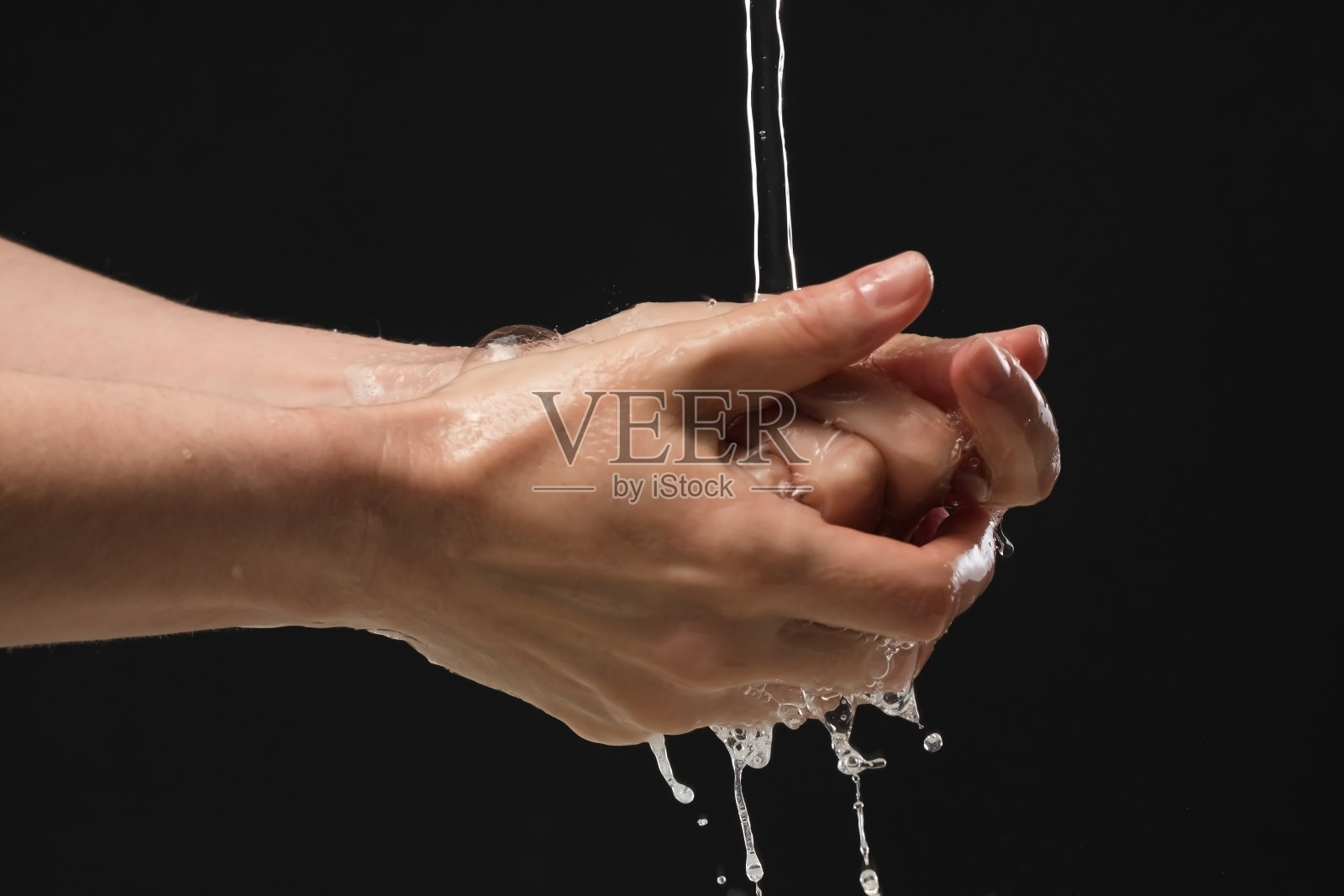 使用酒精洗手液洗手,以防止感染Covid-19病毒和其他病毒。照片摄影图片