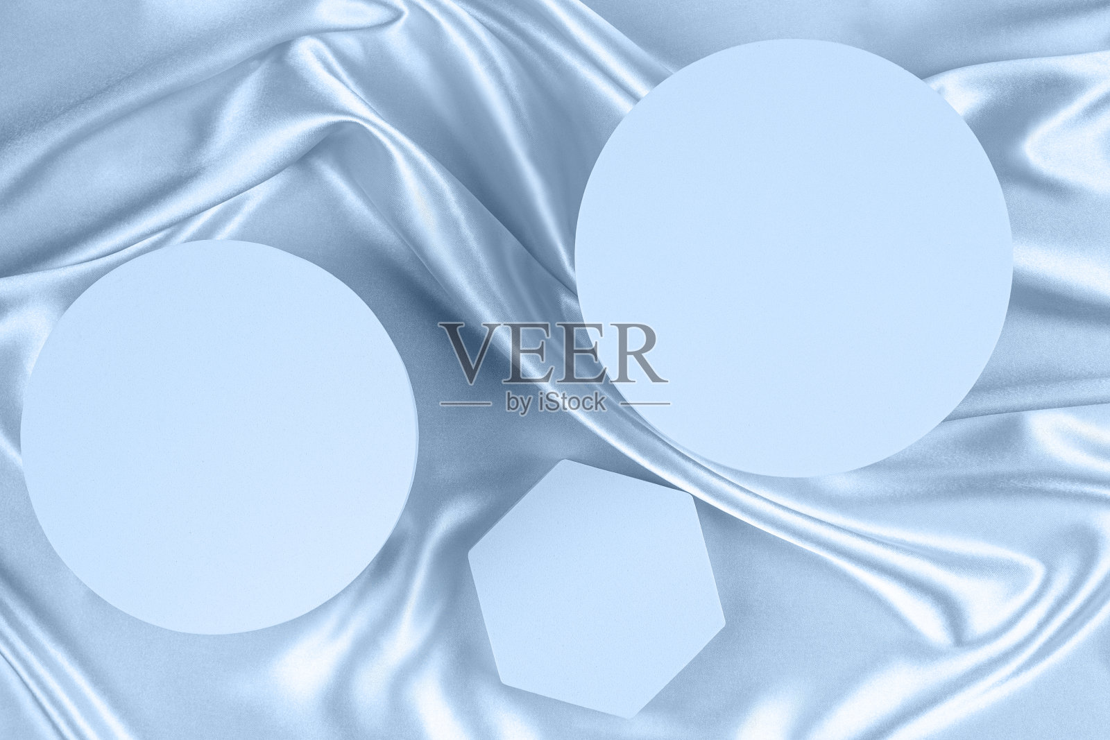 几何圆形平台讲台在浅蓝色丝绸缎子背景。空白最小圆柱体形式模拟背景化妆品展示。俯视图照片摄影图片