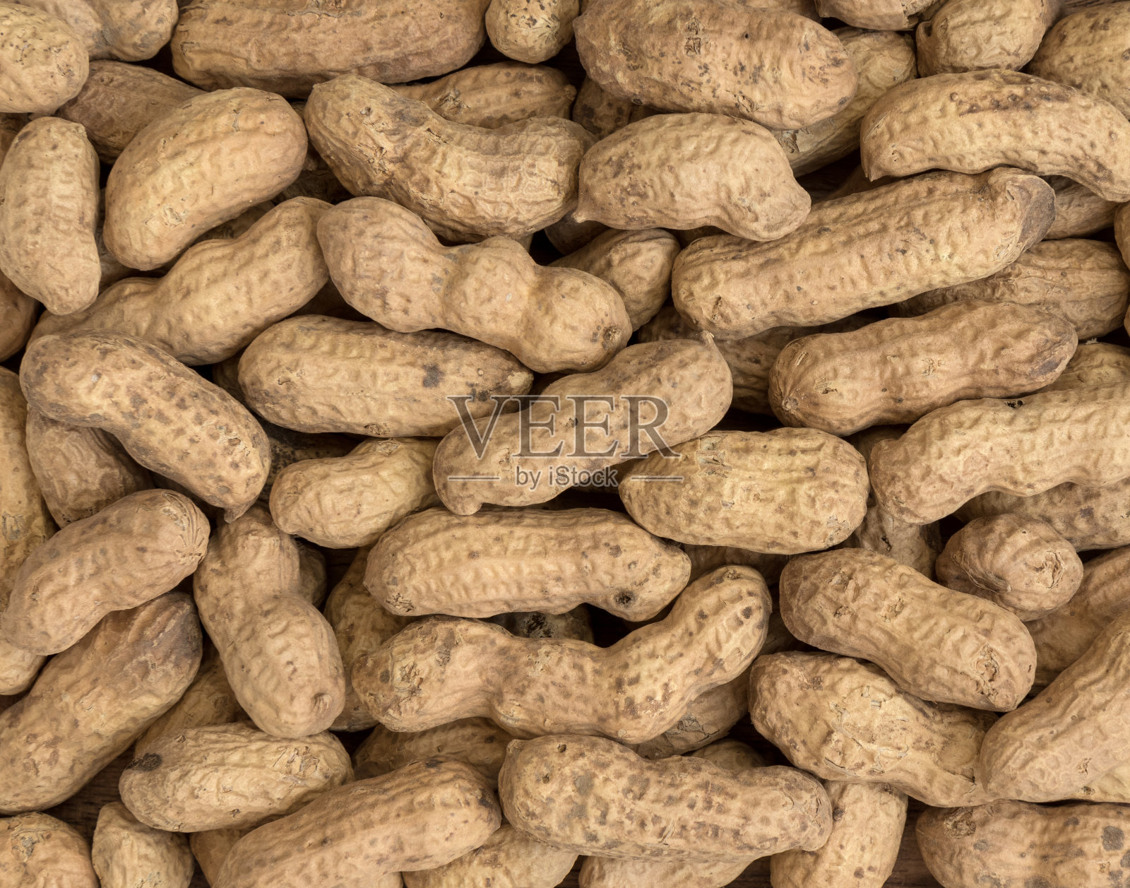 花生种子。许多带壳的花生。花生的背景照片摄影图片