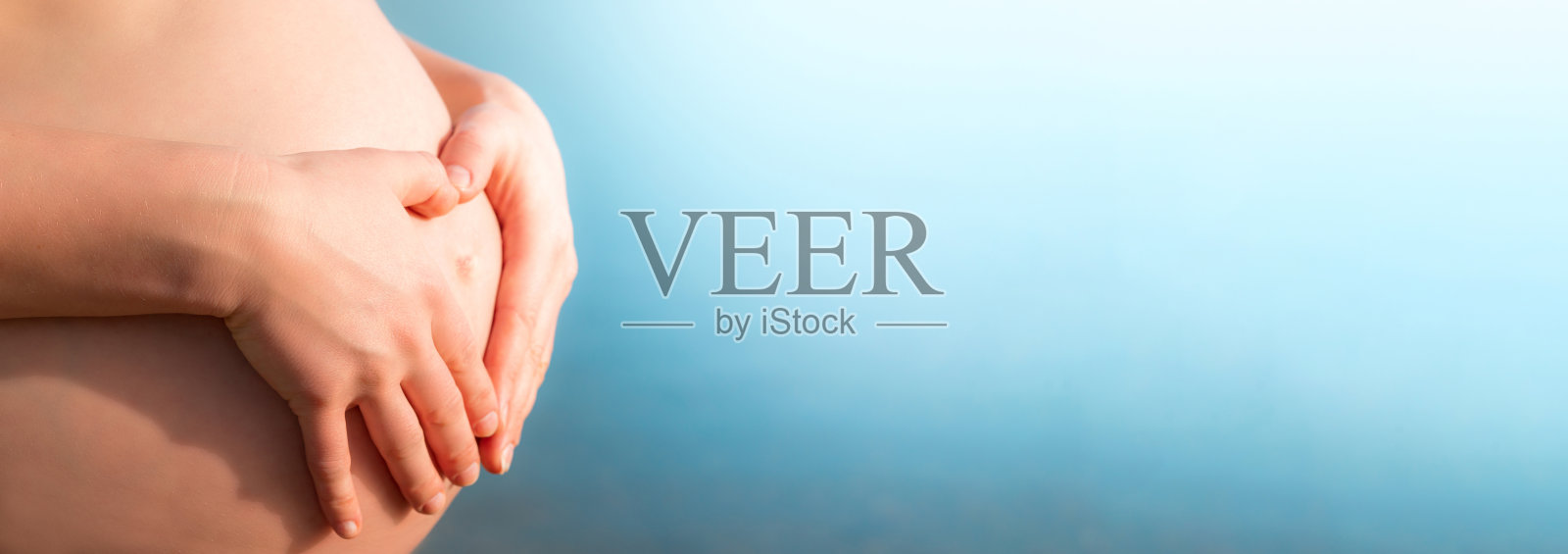 孕妇摸着自己的肚子照片摄影图片