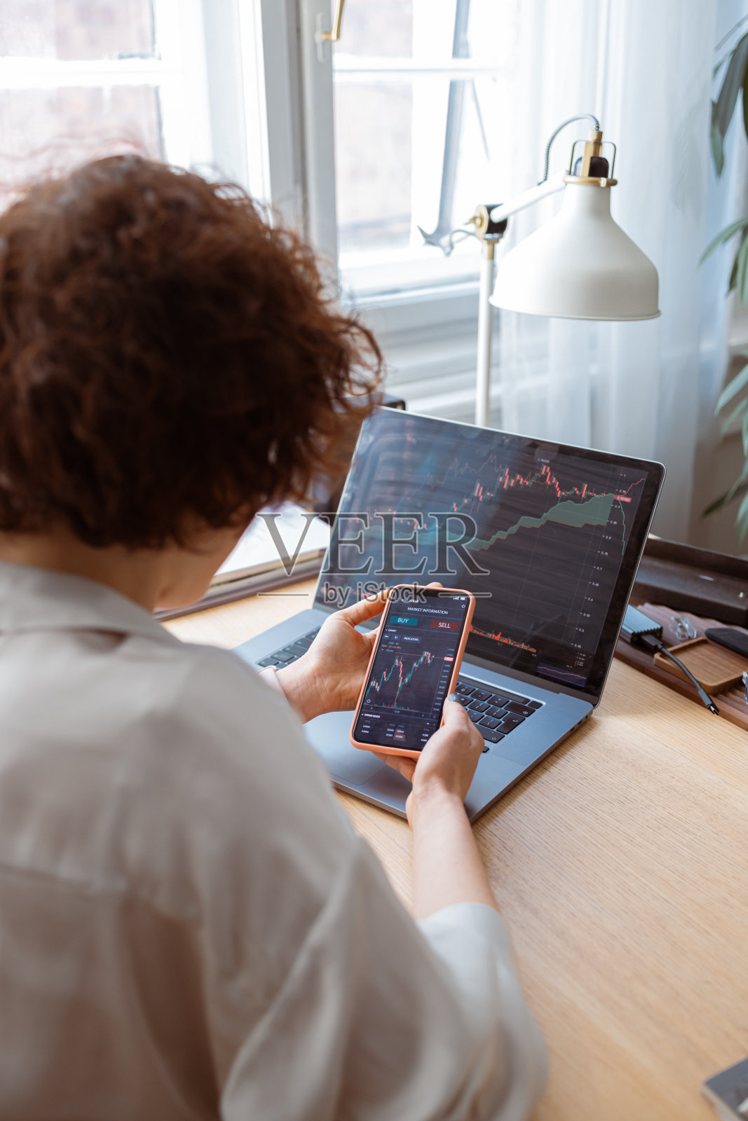 在手机上看股票图表的女商人照片摄影图片