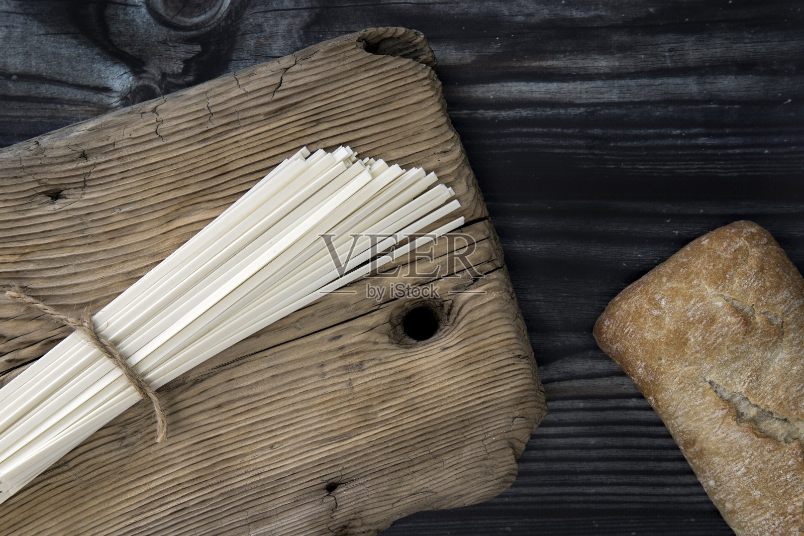 面包,小圆面包,佛卡夏,夏巴塔,乌冬,意大利面,面粉产品在一个木制的背景。地中海厨房。俯视图照片摄影图片