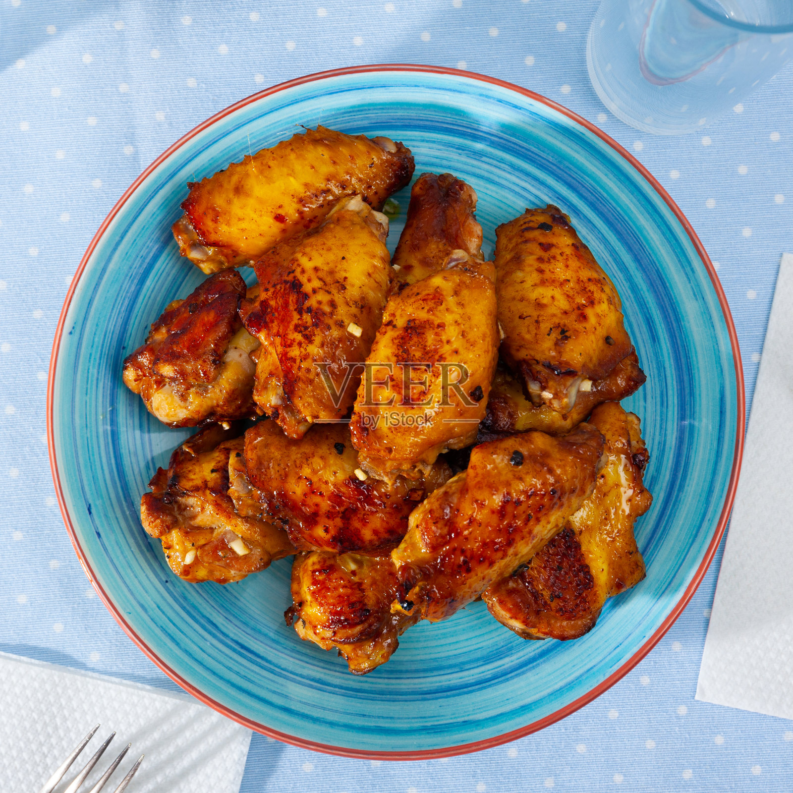 午餐用蓝色盘子烤辣水牛城鸡翅照片摄影图片