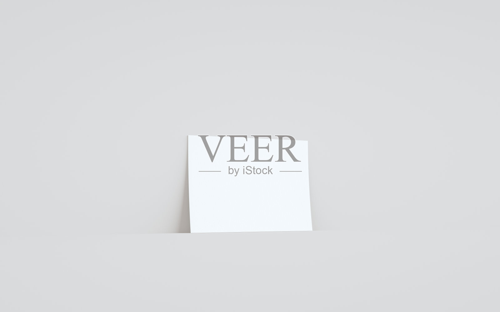 A5传单/小册子模型-一个传单对着墙的背景照片摄影图片