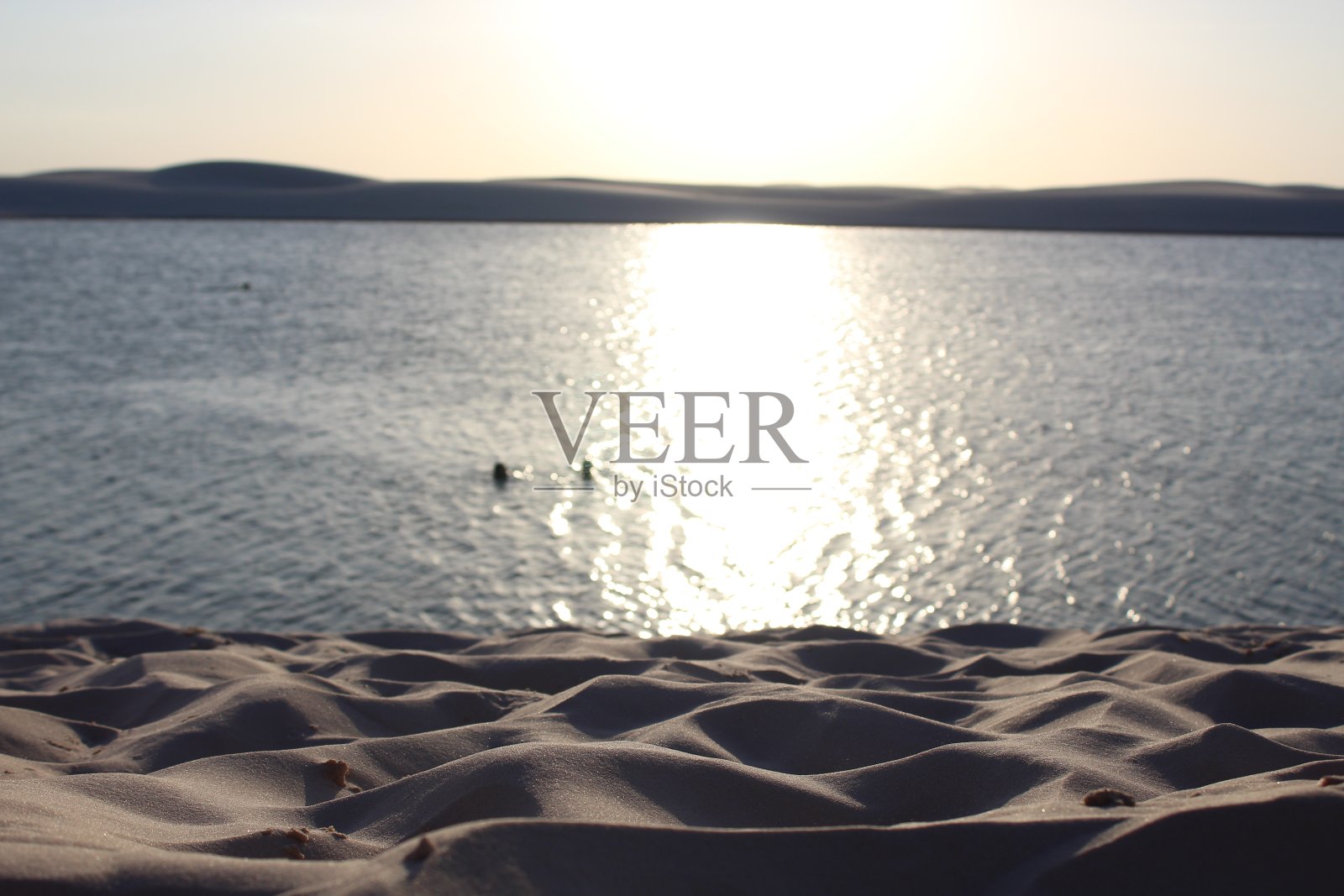 在Lençóis Maranhenses湖反射的太阳照片摄影图片