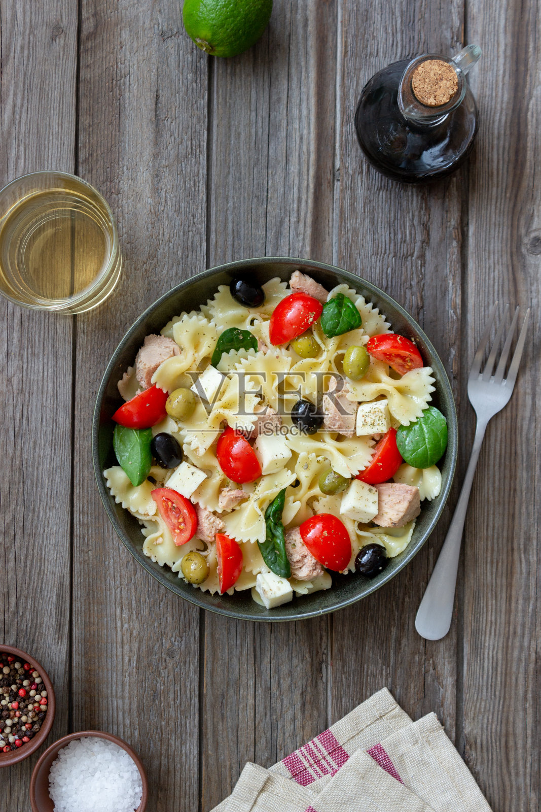 金枪鱼,西红柿和白奶酪的意大利面沙拉。蝴蝶结面。健康饮食。饮食。照片摄影图片