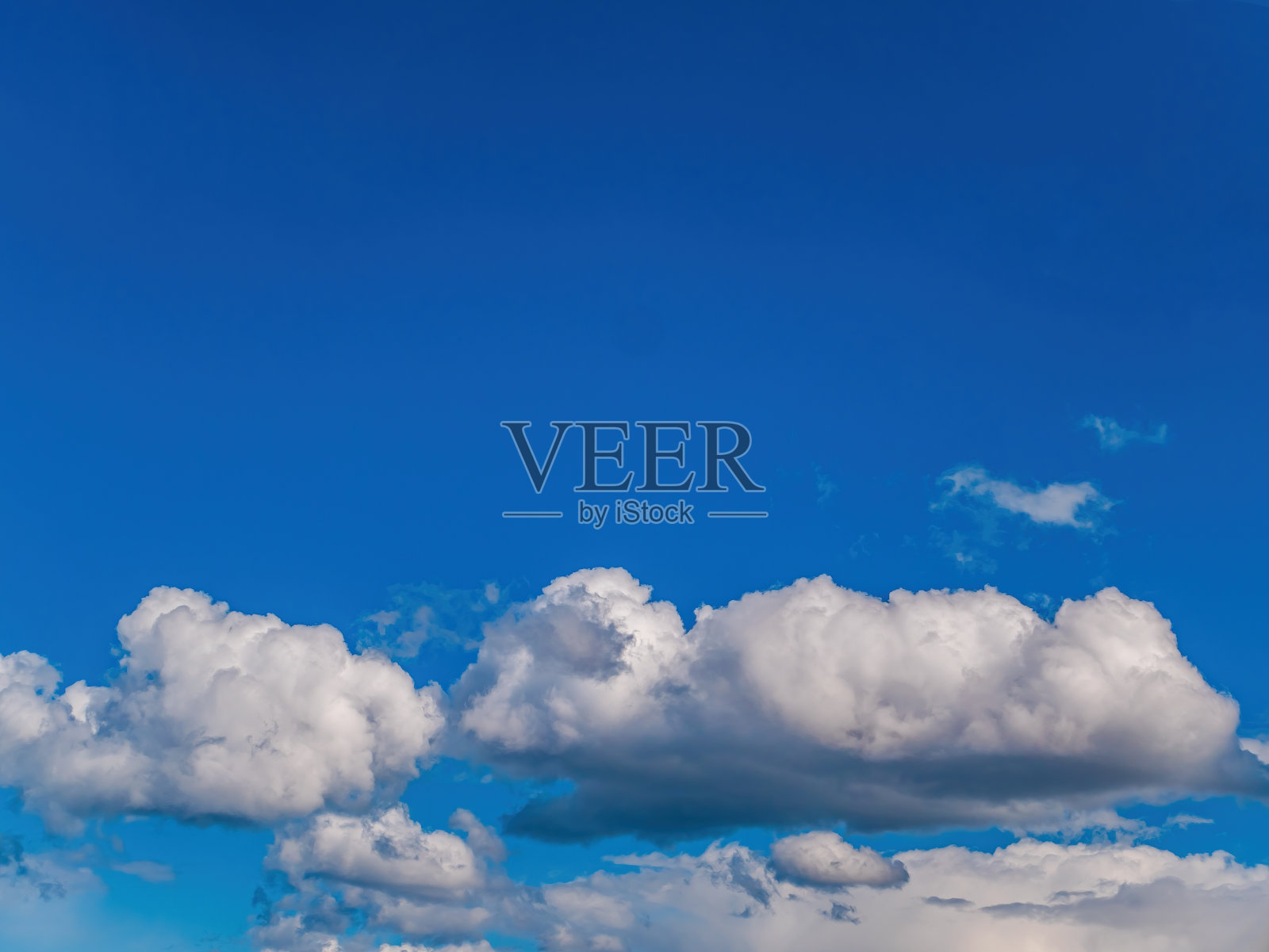 阳光下,蓝天映衬着白云。照片摄影图片