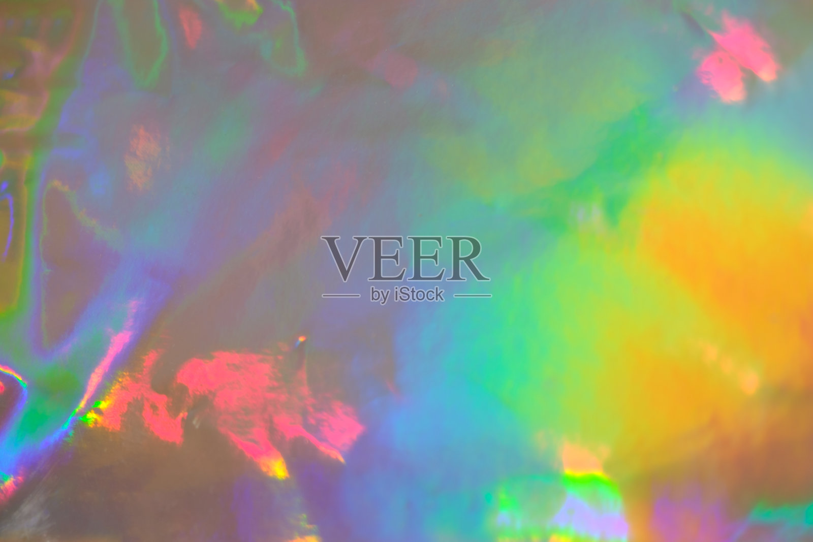 摘要全息彩虹箔纹理背景具有彩虹色斑点照片摄影图片