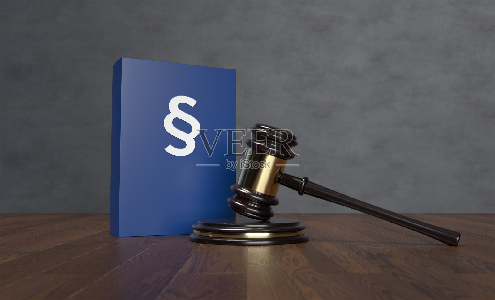 木地板和灰色墙壁上的法槌与蓝色法律书籍照片摄影图片