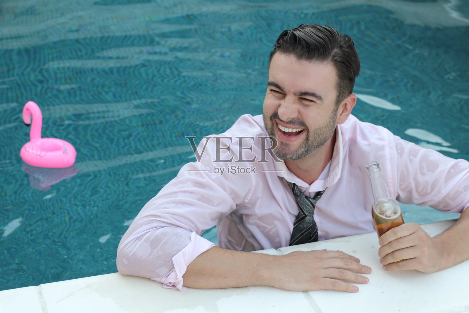 放松的企业家在泳池里喝湿了的水照片摄影图片