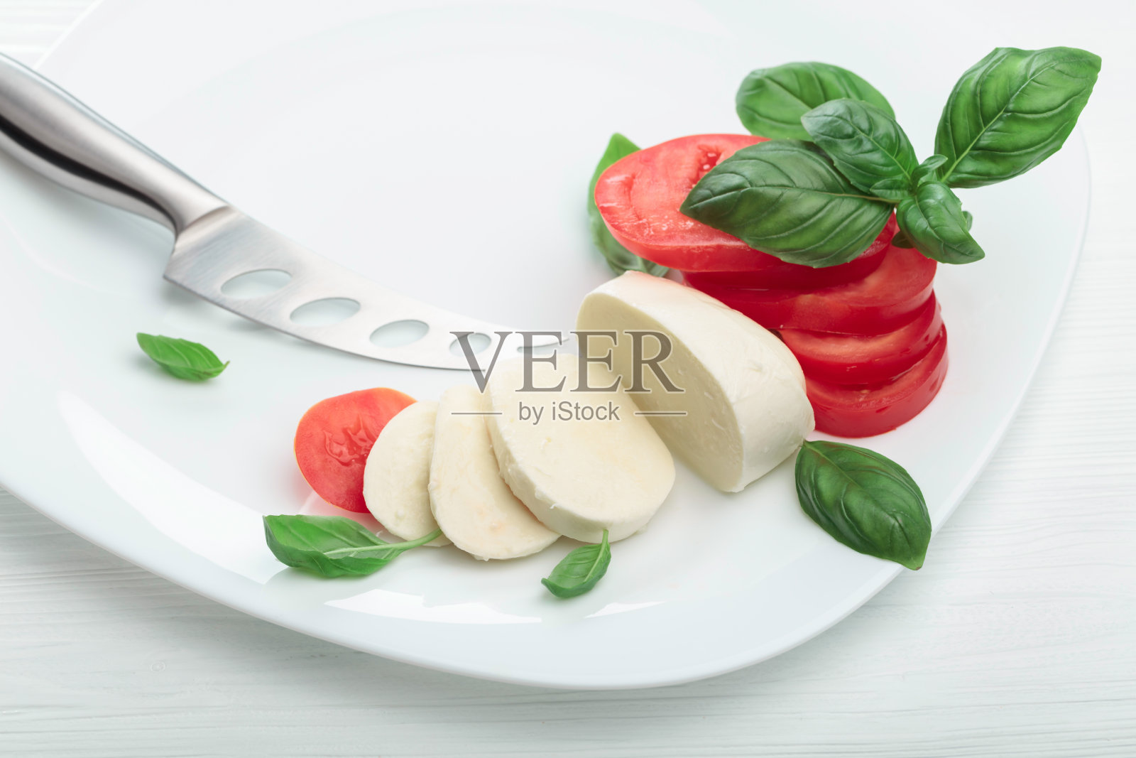 马苏里拉奶酪配西红柿和罗勒。照片摄影图片
