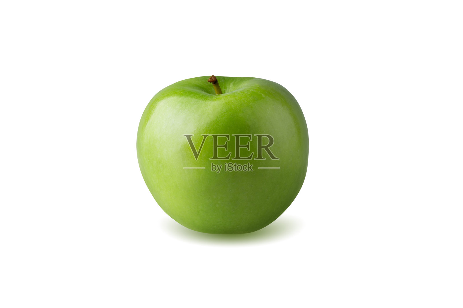 绿色的苹果,叶子是绿色的,在白色的背景上切成带种子的薄片。照片摄影图片