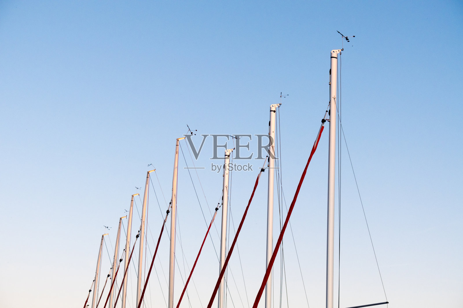 夕阳西下的帆船桅杆照片摄影图片