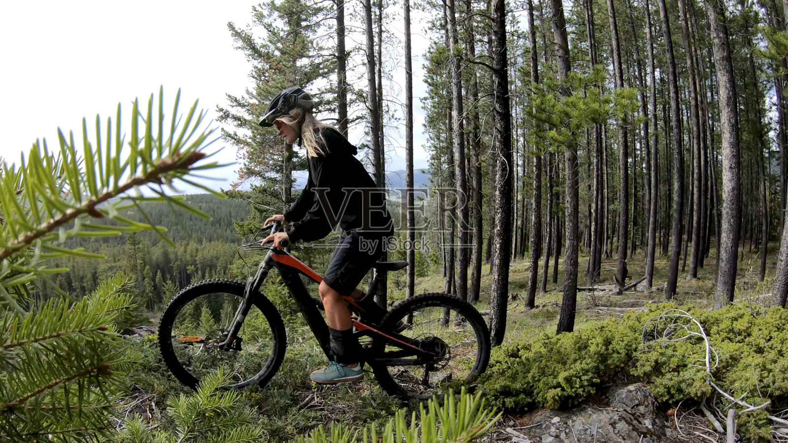 女性山地自行车沿着森林小径照片摄影图片
