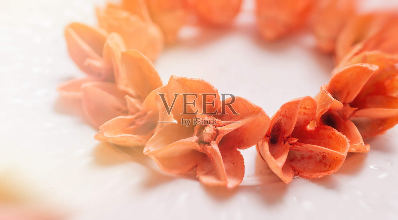 橙色的花蕾聚集在一个盘子上。左边是明亮和模糊的背景。照片摄影图片