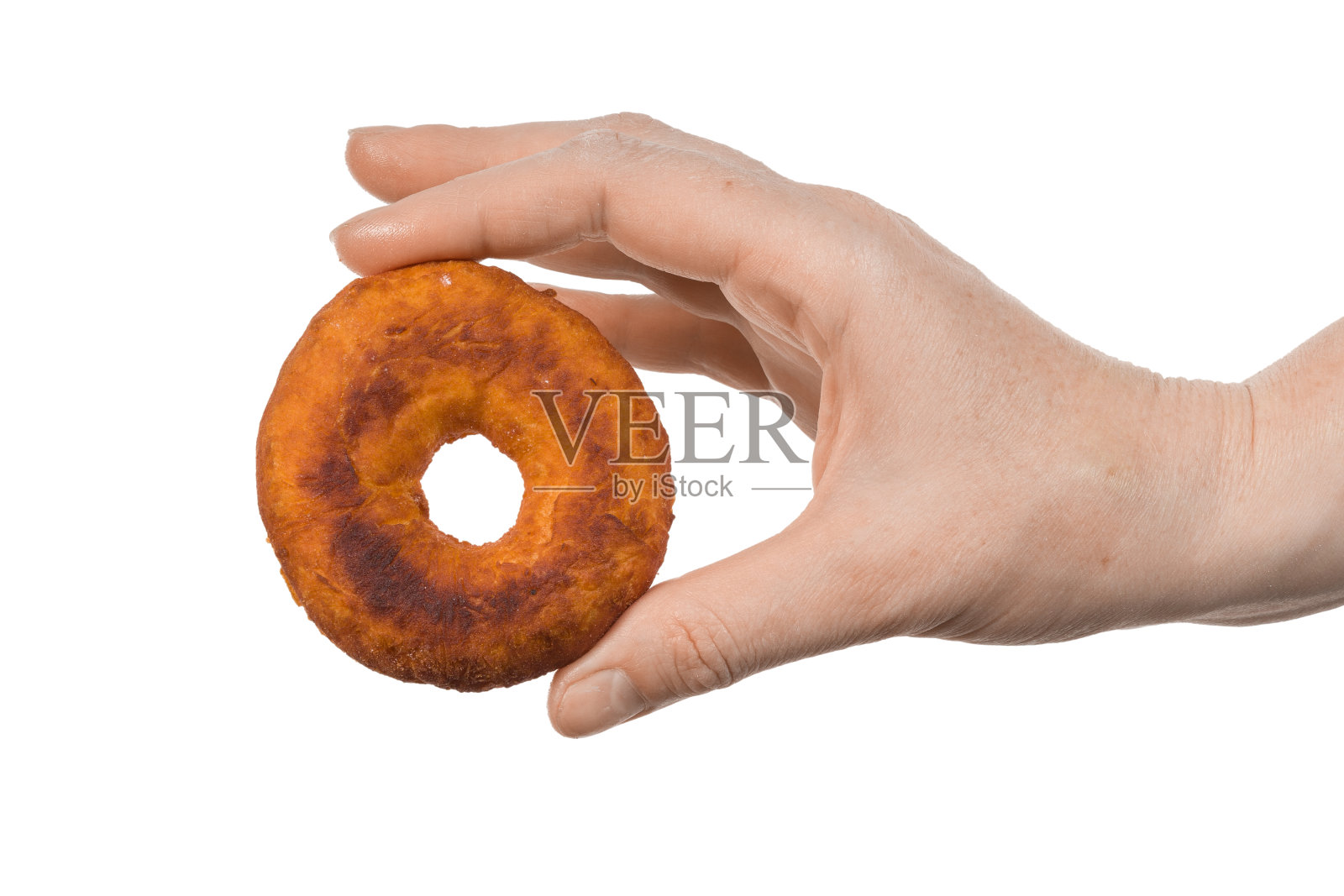 油炸甜甜圈在女性手中白色孤立的背景照片摄影图片
