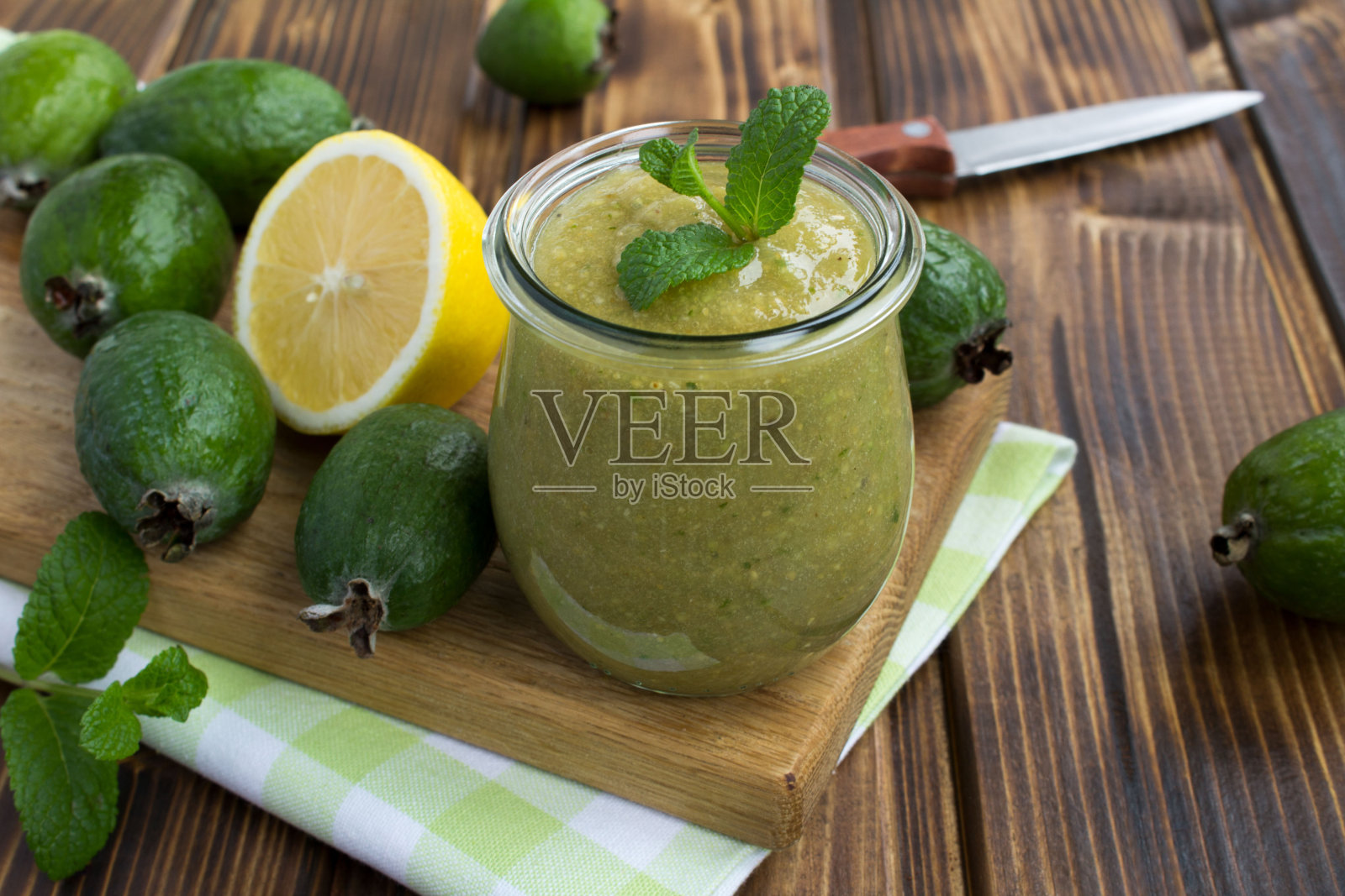 木桌子上的玻璃罐里的feijoa泥照片摄影图片